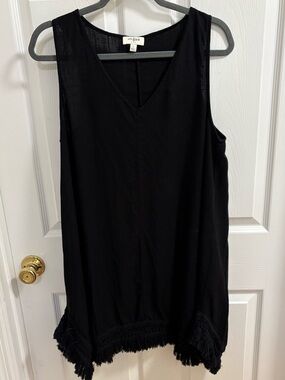 Umgee black sleeveless V-neck dress featuring a fringe-trimmed hemline., flows
